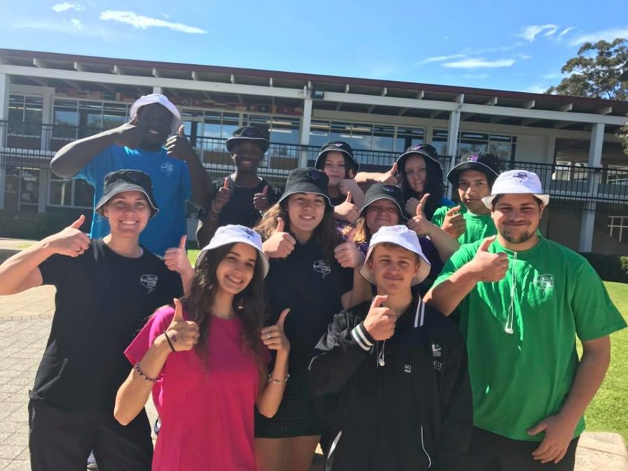 High School Students with thumbs up in courtyard