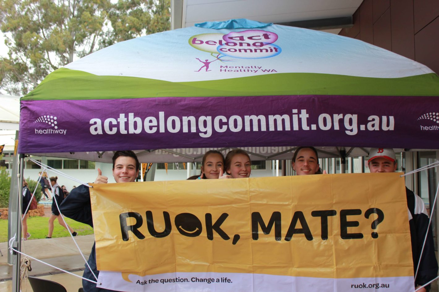 students holding sign saying 