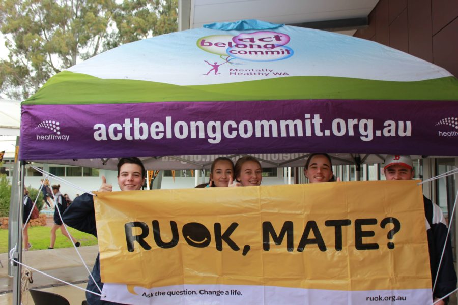 students holding sign saying 