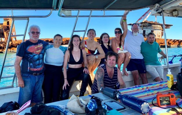 group on nine people on a boat