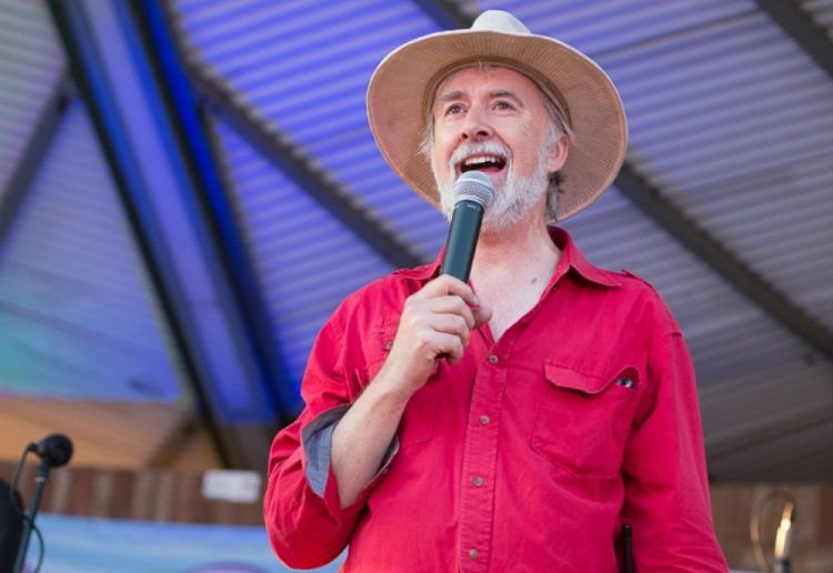 man with red shirt and hat with microhpone