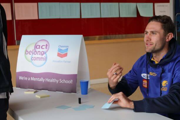man sitting with sign