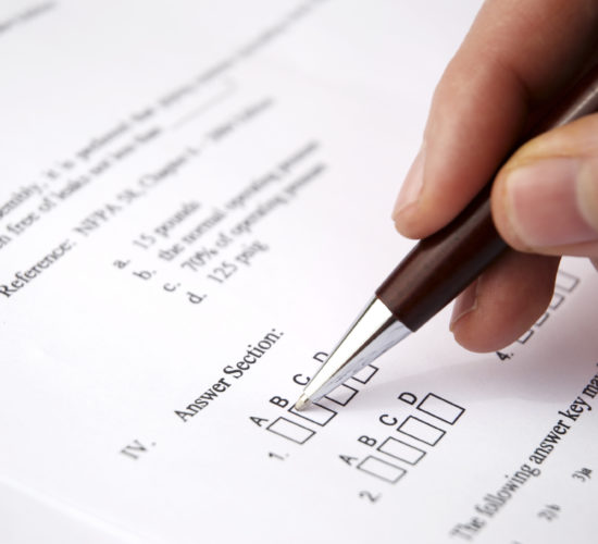 Hand with pen filling in a questionnaire